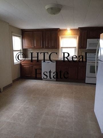 Elizabethtown apartment for rent - A kitchen with brown cabinets and a white refrigerator.