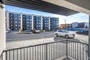 Edmonton apartment for rent - A white car is parked in a parking lot in front of a building.at Hills on 36, Edmonton, T6X 3K2