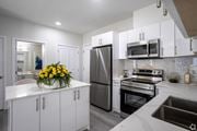 Edmonton apartment for rent - A modern kitchen with white cabinets and stainless steel appliances.at Hills on 36, Edmonton Alberta