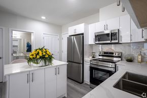 Edmonton apartment for rent - A modern kitchen with white cabinets and stainless steel appliances.at Hills on 36, Edmonton Alberta