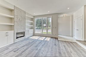 Calgary apartment for rent - A spacious living room with a fireplace and a large window.