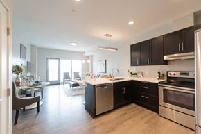 Edmonton apartment for rent - A modern kitchen with a dining table and chairs.