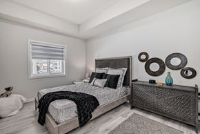 Edmonton apartment for rent - a bedroom with a large bed and a window