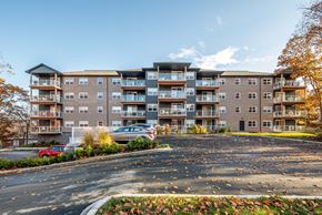 Dartmouth apartment for rent - A large apartment complex with a parking lot in front.