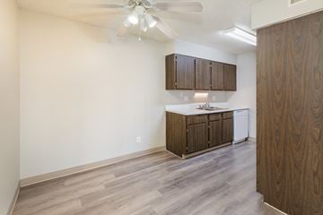 Colorado Springs apartment for rent - A kitchen with wooden cabinets and a ceiling fan.