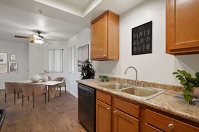 Santa Ana apartment for rent - A kitchen with a table and chairs in the middle of the room.