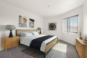 Santa Ana apartment for rent - A bedroom with a bed, nightstand, and lamp.