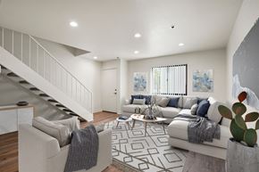 Anaheim apartment for rent - A living room with a staircase and a couch.