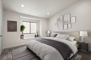 Anaheim apartment for rent - A bedroom with a large bed and a window with blinds.