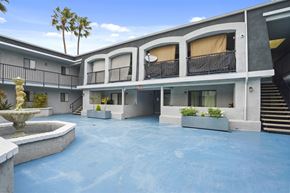 Santa Ana apartment for rent - A courtyard with a fountain and a pool.