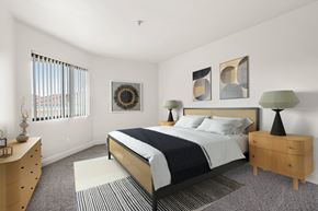Anaheim apartment for rent - A bedroom with a bed, nightstand, and a dresser.