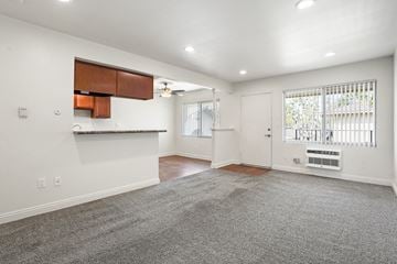 Anaheim apartment for rent - A spacious living room with a grey carpet and white walls.