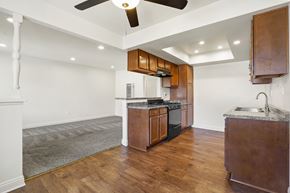 Anaheim apartment for rent - A kitchen with wooden cabinets and a white ceiling fan.