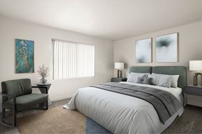 Anaheim apartment for rent - A bedroom with a large bed, a chair, and a painting on the wall.