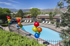 Colorado Springs apartment for rent - A pool surrounded by trees and balloons.