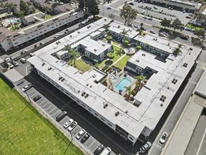 Anaheim apartment for rent - A large building with a pool in the middle of it.
