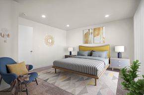 Anaheim apartment for rent - A bedroom with a bed, chair, and lamp.