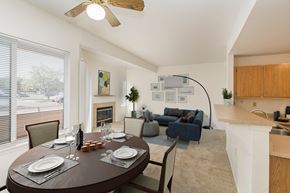 Colorado Springs apartment for rent - A dining room with a table set for two and a kitchen area in the background.