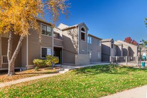 Littleton apartment for rent - A row of houses with a tree in front of them.