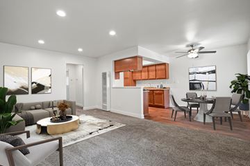 Anaheim apartment for rent - A modern living room with a grey rug and a grey sofa.