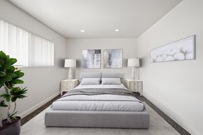 Anaheim apartment for rent - A bedroom with a large bed and two lamps.