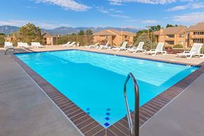 Colorado Springs apartment for rent - A swimming pool with a ladder and sun loungers.
