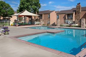 Colorado Springs apartment for rent - A swimming pool surrounded by a patio and a gazebo.