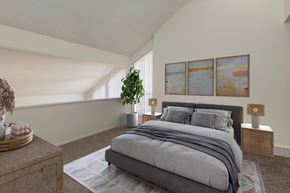Colorado Springs apartment for rent - A bedroom with a large bed and a potted plant.