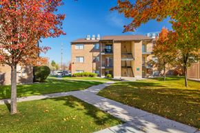 Taylorsville apartment for rent - A building with a red tree in front of it.
