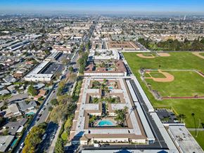 Anaheim apartment for rent - A large building with a pool in the middle of it.