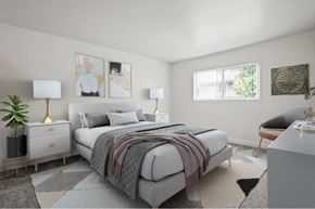 Anaheim apartment for rent - A bedroom with a large bed and a plant on the nightstand.