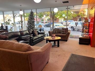 Vancouver apartment for rent - A living room with a brown couch and a coffee table.