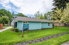 Scappoose apartment for rent - a blue house with a welcome sign in front of it