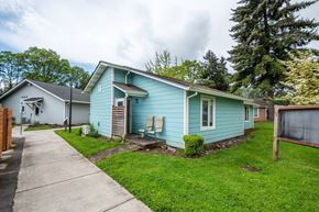 Scappoose apartment for rent - a blue house with a sidewalk in front of it
