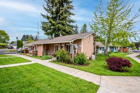 Scappoose apartment for rent - a small pink house with a sidewalk in front of it