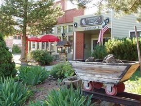 Roslyn apartment for rent - a boat sitting in a garden in front of a building