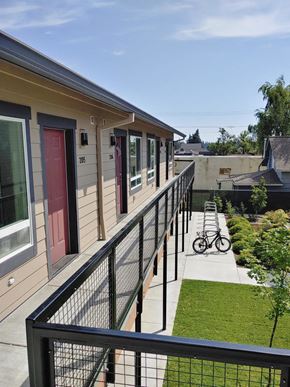 St Helens apartment for rent - a view of a balcony of a building with a bike parked on it