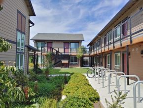 St Helens apartment for rent - a courtyard with a patio and chairs in front of a building