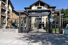 Portland apartment for rent - a gate is open in front of a building with a playground in the background