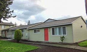 Portland apartment for rent - a yellow house with a red door and a yard