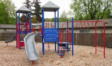 Portland apartment for rent - a playground with a swing set and slides