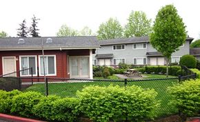 Portland apartment for rent - a house with a yard and a fence in front of it