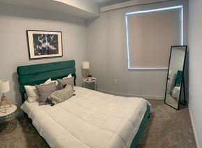 Vancouver apartment for rent - a bedroom with a large bed and a mirror