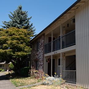 Portland apartment for rent - A building with a balcony and a tree in front of it.