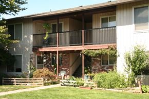 Portland apartment for rent - A house with a balcony and a garden in front.