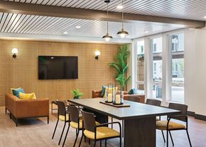 Portland apartment for rent - a conference room with a table and chairs and a television