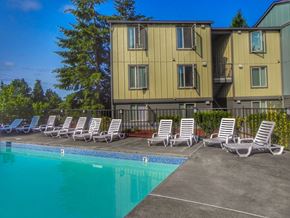 Happy Valley apartment for rent - A pool with chairs and a building in the background.