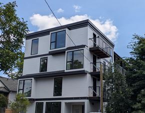 Portland apartment for rent - A modern multi-story building with balconies and large windows.