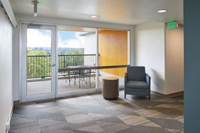 Milwaukie apartment for rent - a room with a chair and a table on a balcony