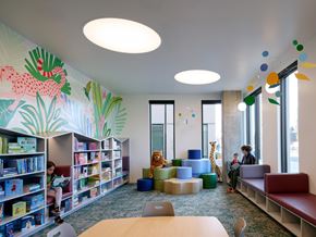 Portland apartment for rent - A brightly lit children's library with a mural of a dragon on the wall.